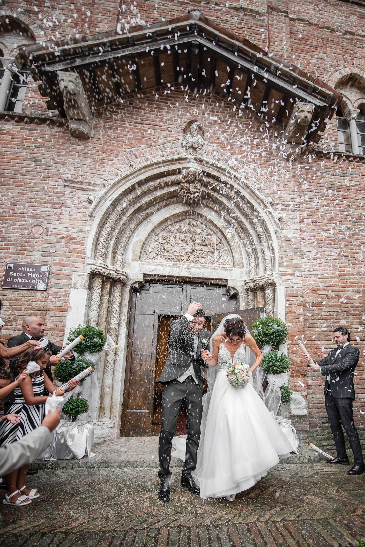 sposi durante il lancio del riso fuori dalla chiesa di Sarnano